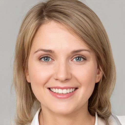 Joyful white young-adult female with medium  brown hair and blue eyes