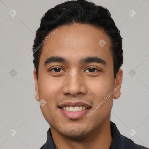 Joyful latino young-adult male with short  black hair and brown eyes