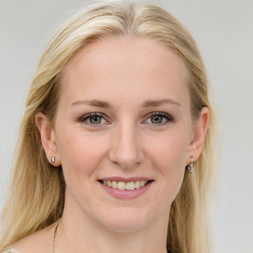 Joyful white young-adult female with long  brown hair and blue eyes