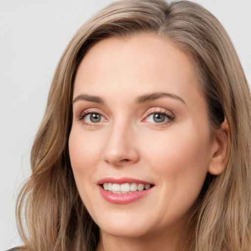 Joyful white young-adult female with long  brown hair and grey eyes