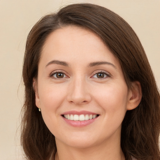 Joyful white young-adult female with long  brown hair and brown eyes