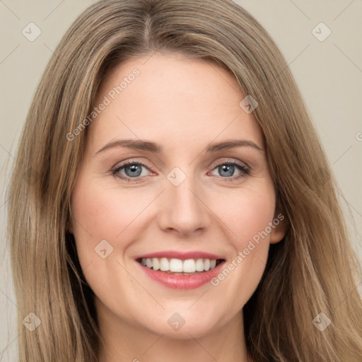 Joyful white young-adult female with long  brown hair and green eyes