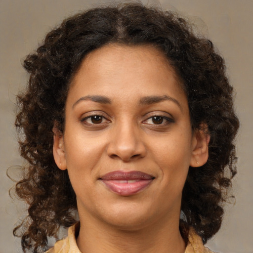 Joyful latino adult female with medium  brown hair and brown eyes