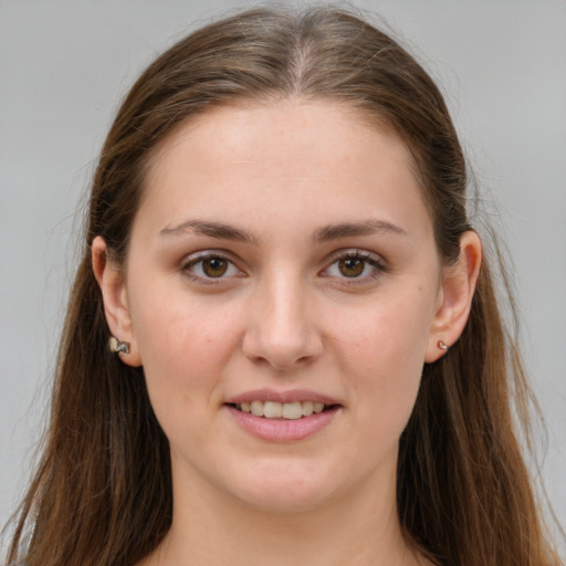 Joyful white young-adult female with long  brown hair and grey eyes