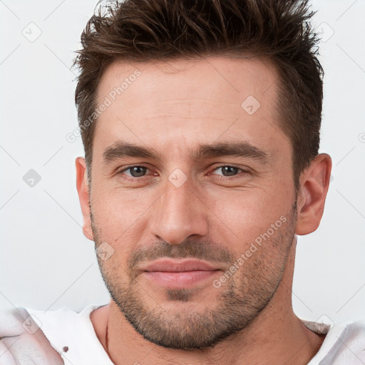 Joyful white young-adult male with short  brown hair and brown eyes