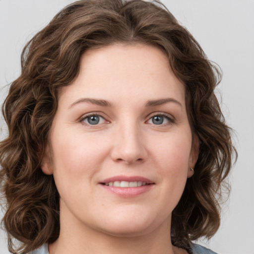 Joyful white young-adult female with medium  brown hair and green eyes