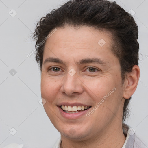 Joyful white adult male with short  brown hair and brown eyes