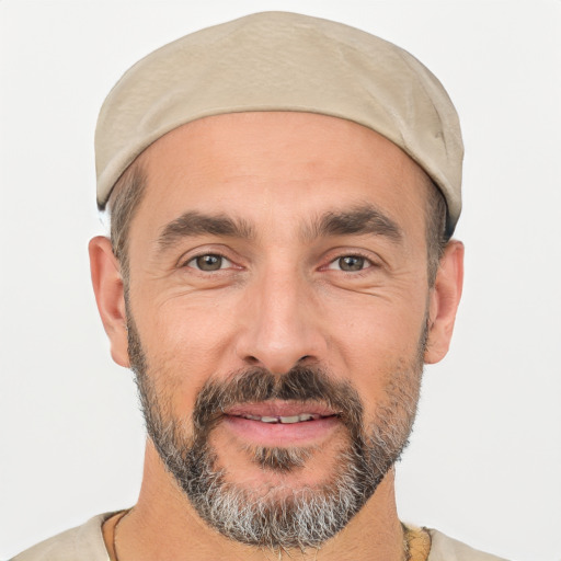 Joyful white adult male with short  black hair and brown eyes