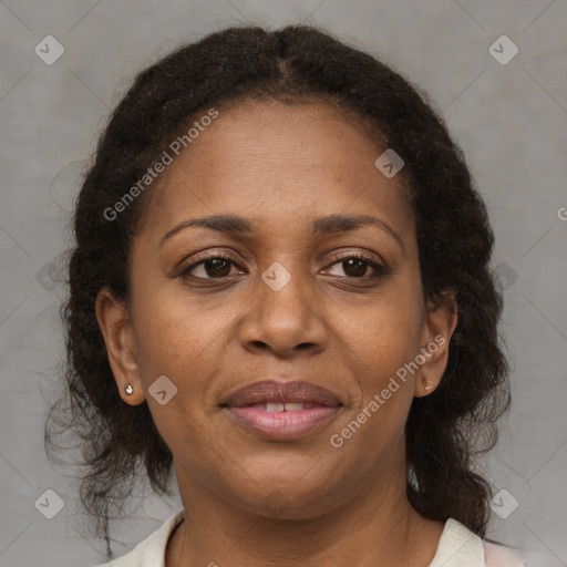 Joyful black adult female with medium  brown hair and brown eyes