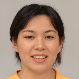 Joyful asian young-adult female with medium  brown hair and brown eyes