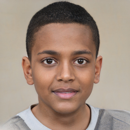 Joyful black child male with short  brown hair and brown eyes