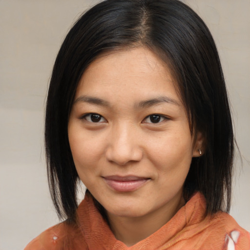 Joyful asian young-adult female with medium  brown hair and brown eyes