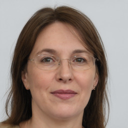 Joyful white adult female with medium  brown hair and grey eyes