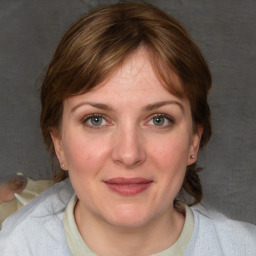 Joyful white young-adult female with medium  brown hair and blue eyes