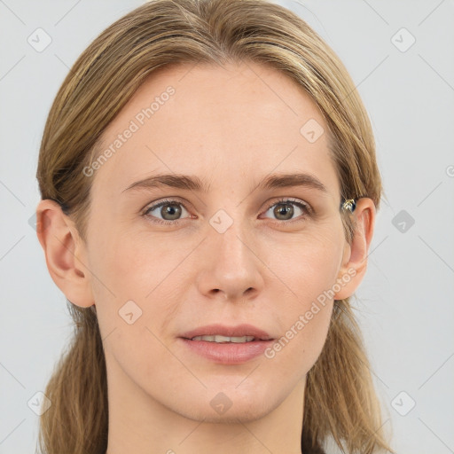 Joyful white young-adult female with long  brown hair and blue eyes