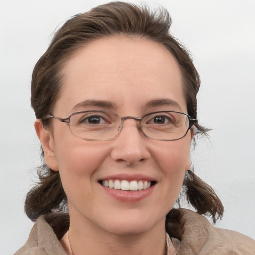 Joyful white adult female with medium  brown hair and grey eyes