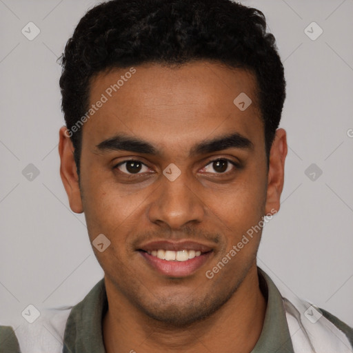 Joyful black young-adult male with short  black hair and brown eyes