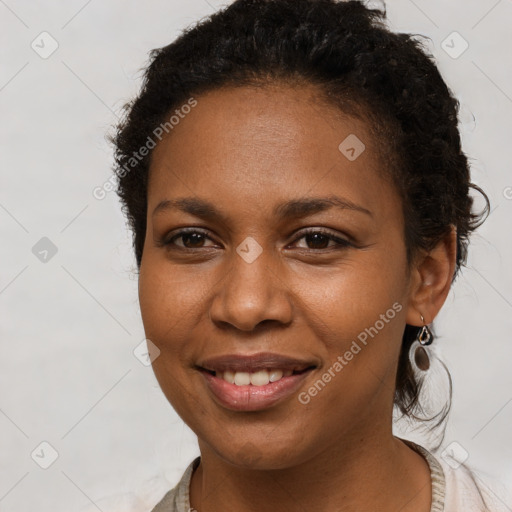 Joyful black young-adult female with short  brown hair and brown eyes