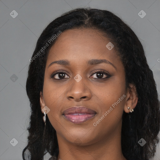 Joyful black young-adult female with long  brown hair and brown eyes