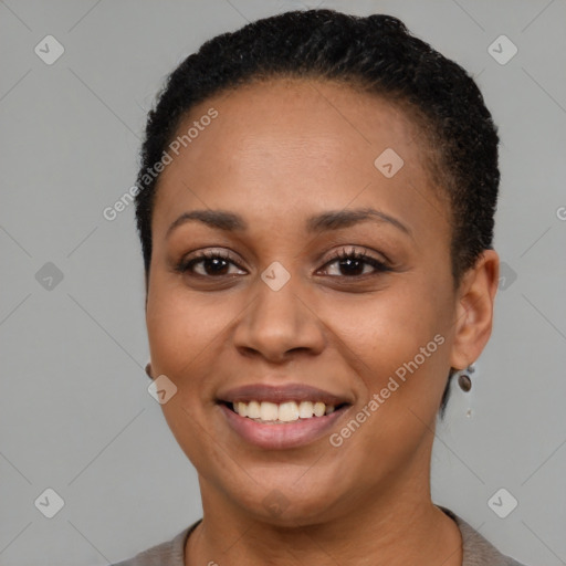 Joyful black young-adult female with short  brown hair and brown eyes