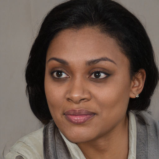 Joyful black young-adult female with medium  black hair and brown eyes