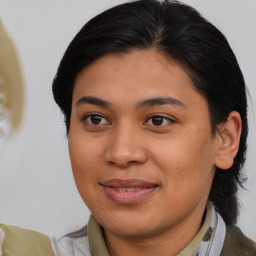 Joyful asian young-adult female with medium  brown hair and brown eyes