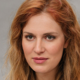 Joyful white young-adult female with long  brown hair and green eyes