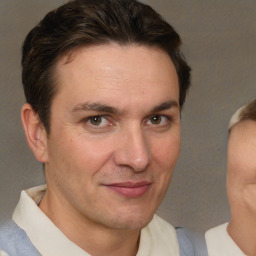 Joyful white adult male with short  brown hair and brown eyes