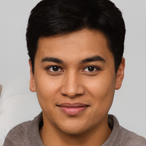 Joyful asian young-adult male with short  brown hair and brown eyes