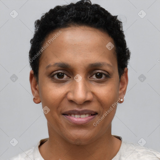 Joyful black young-adult female with short  black hair and brown eyes