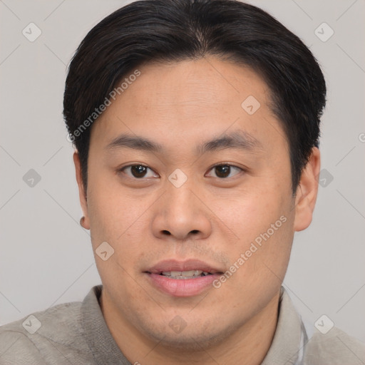 Joyful asian young-adult male with short  brown hair and brown eyes