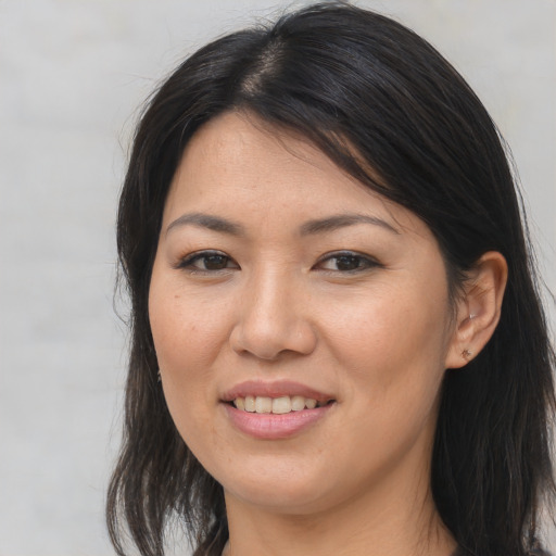 Joyful asian young-adult female with medium  brown hair and brown eyes