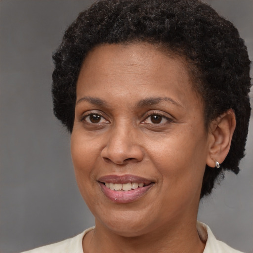 Joyful black adult female with short  brown hair and brown eyes
