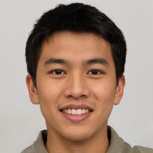 Joyful asian young-adult male with short  brown hair and brown eyes