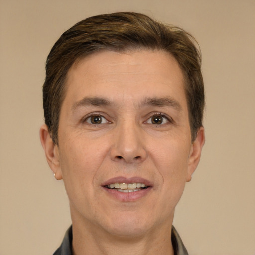 Joyful white adult male with short  brown hair and brown eyes