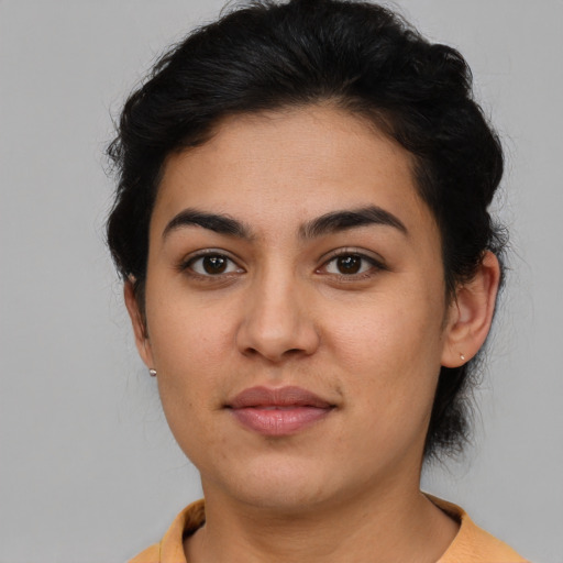 Joyful latino young-adult female with short  brown hair and brown eyes