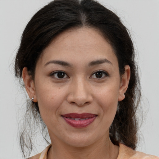 Joyful white adult female with medium  brown hair and brown eyes
