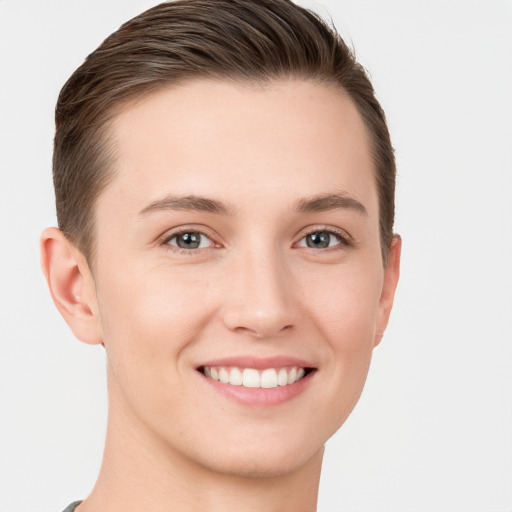 Joyful white young-adult female with short  brown hair and grey eyes