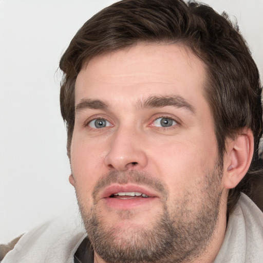 Joyful white adult male with short  brown hair and grey eyes