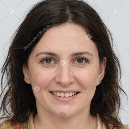 Joyful white adult female with long  brown hair and grey eyes