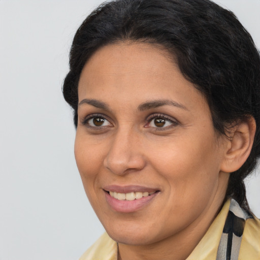 Joyful latino adult female with long  brown hair and brown eyes