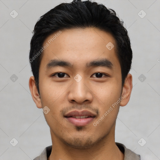 Joyful asian young-adult male with short  black hair and brown eyes