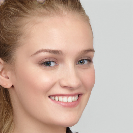 Joyful white young-adult female with long  brown hair and blue eyes