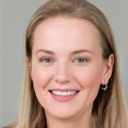 Joyful white young-adult female with long  brown hair and blue eyes