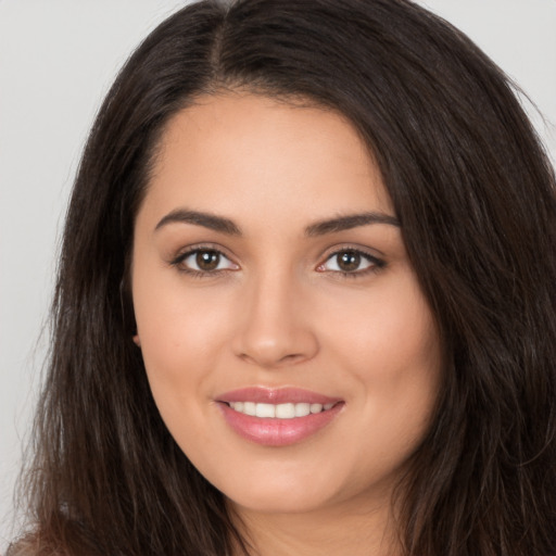 Joyful white young-adult female with long  brown hair and brown eyes