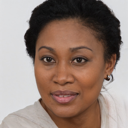 Joyful black young-adult female with short  brown hair and brown eyes