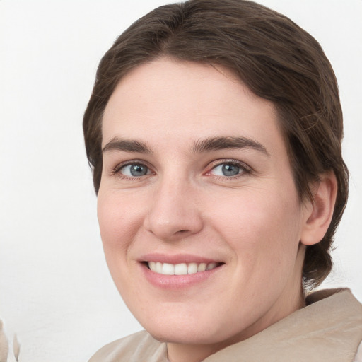 Joyful white young-adult female with medium  brown hair and grey eyes