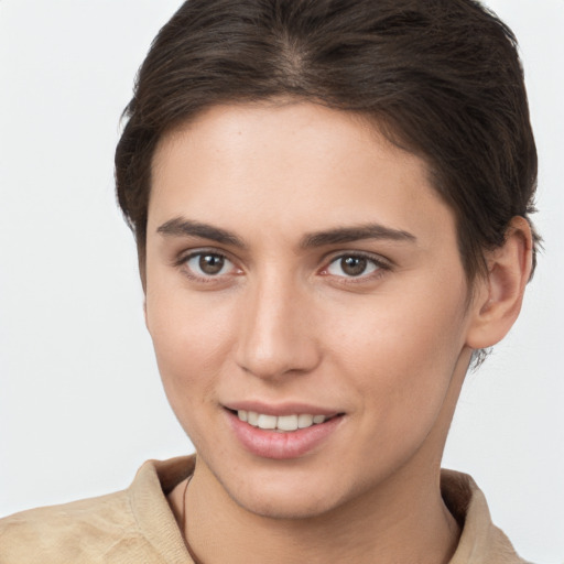 Joyful white young-adult female with short  brown hair and brown eyes