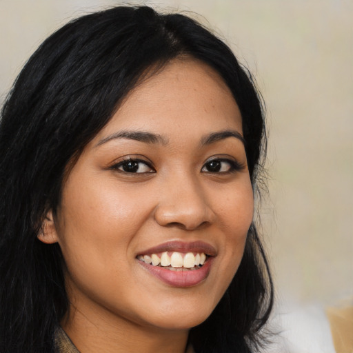 Joyful latino young-adult female with long  black hair and brown eyes