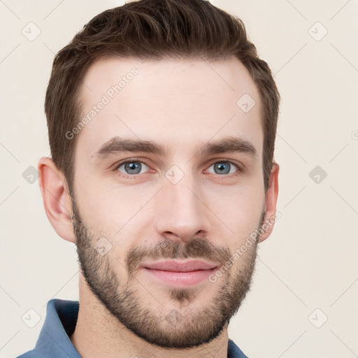 Joyful white young-adult male with short  brown hair and grey eyes